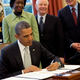 Illustration for article titled Obama Always Freaked Out By People Standing Above Him Smiling Whenever He Signs Bill